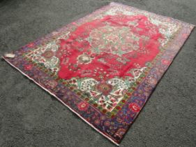 A vintage Persian Tabriz carpet with a multi coloured ground, 276cm x 189cm