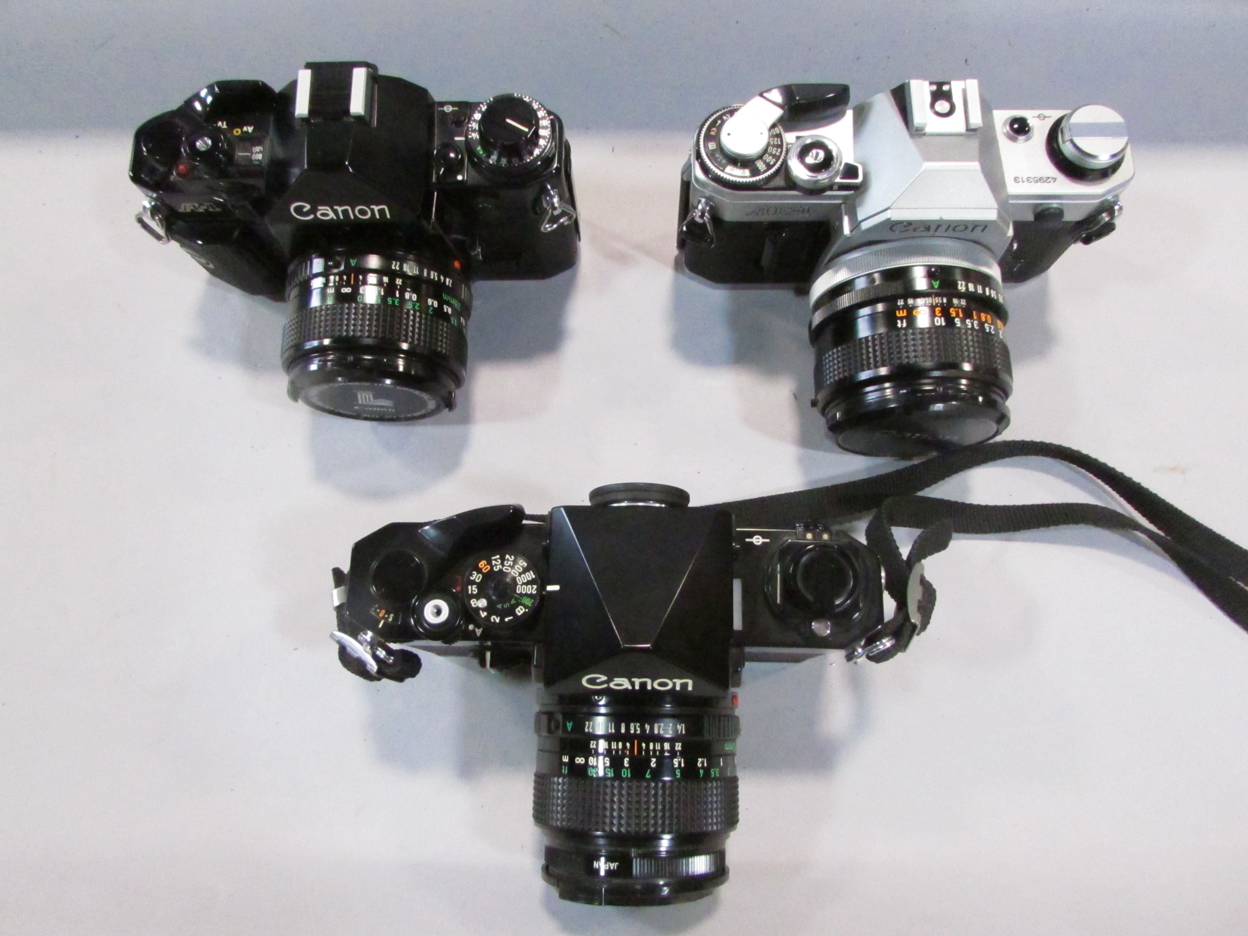 Three Canon cameras: models A1, AE1, F1, together with a 135 millimetre lens, 20 mm lens, all - Image 4 of 5