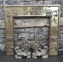 A good 19th century polished brass fire place insert, decorated with applied dragon and Adam style
