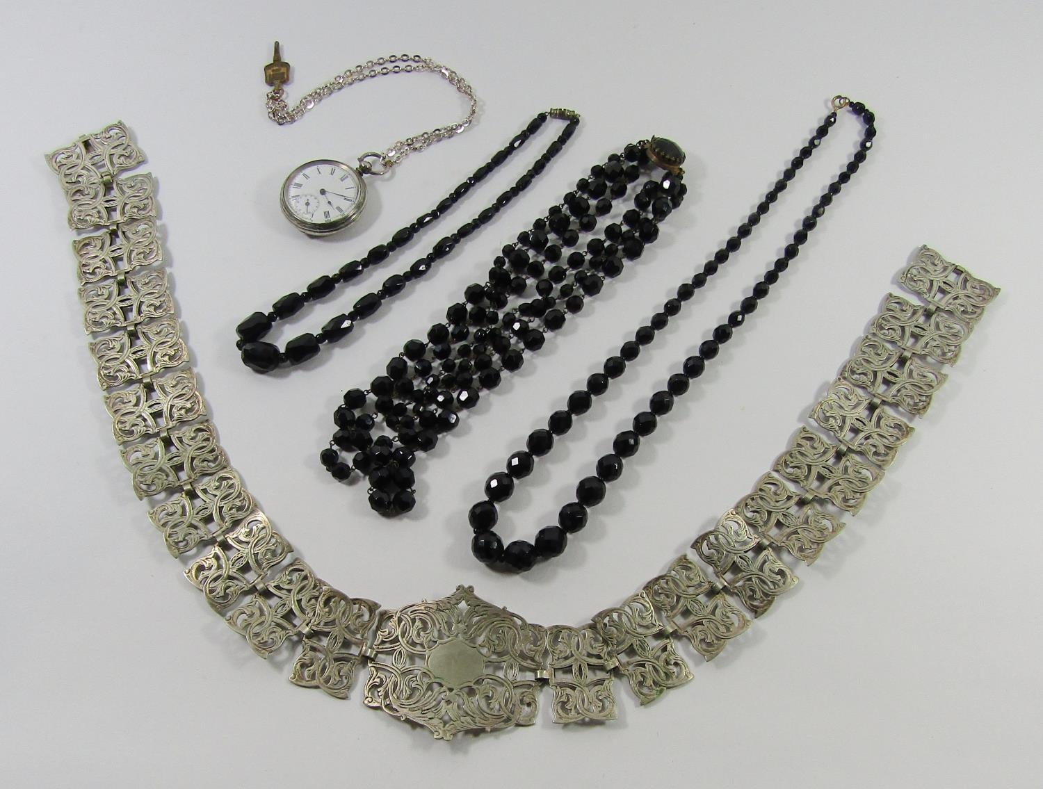 Warranted 800 silver pocket watch, EPNS pierced belt and three French jet bead necklaces (5)