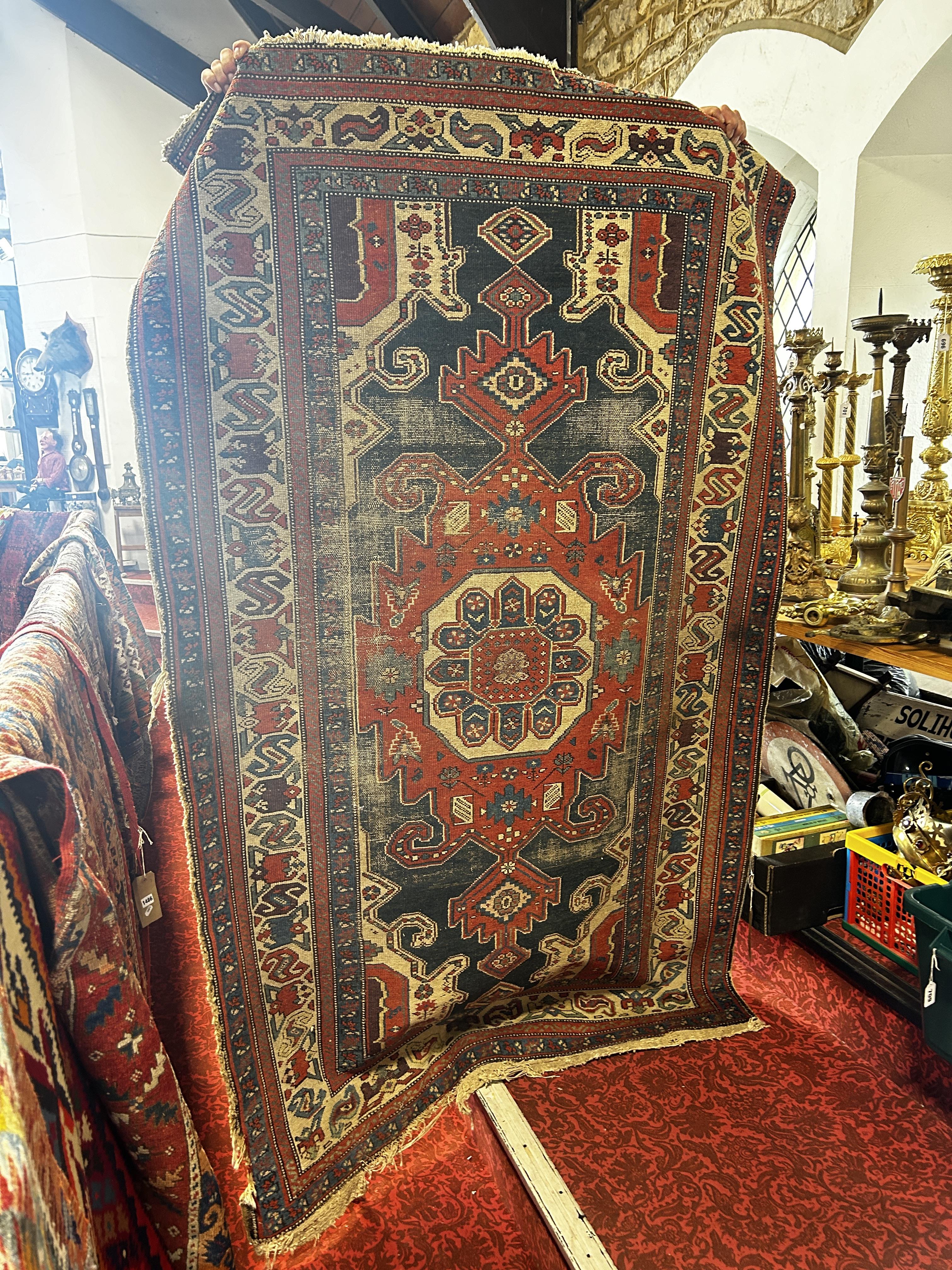 An old tribal Kazak Persian rug with an all over geometric pattern, worn in places, 204cm x 125cm - Image 2 of 3