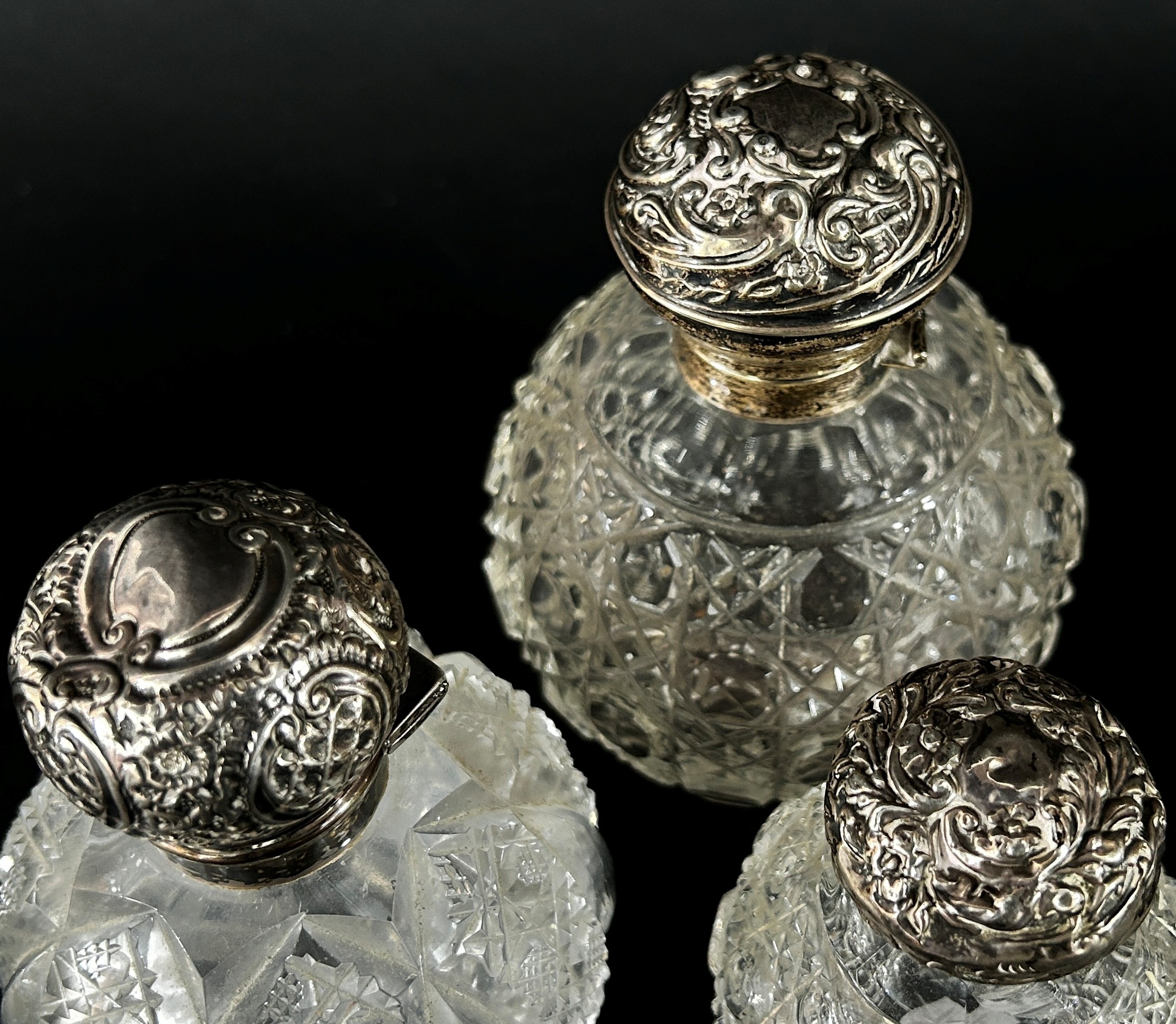 Three 19th century cut glass perfume bottles all with silver caps - Image 3 of 3