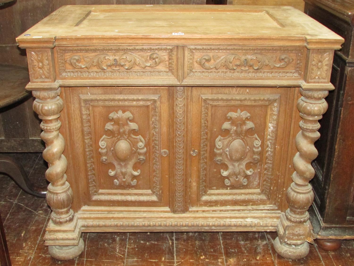 A 19th century oak side cupboard enclosed by two carved and panelled doors with two frieze drawers - Image 2 of 4