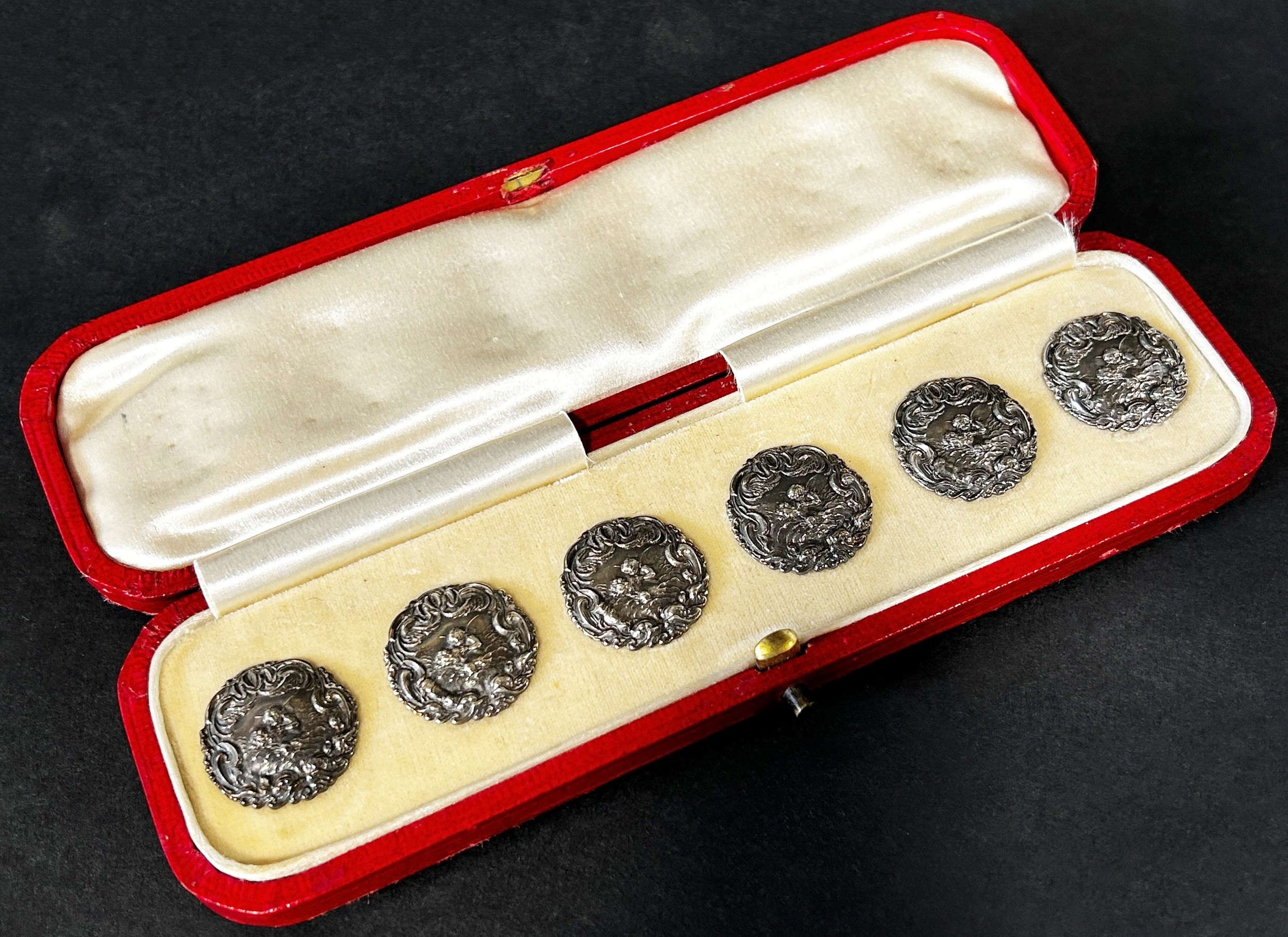 Six Levi & Salaman silver buttons of Cupid reviving Psyche all contained in a red Moroccan leather - Image 2 of 3