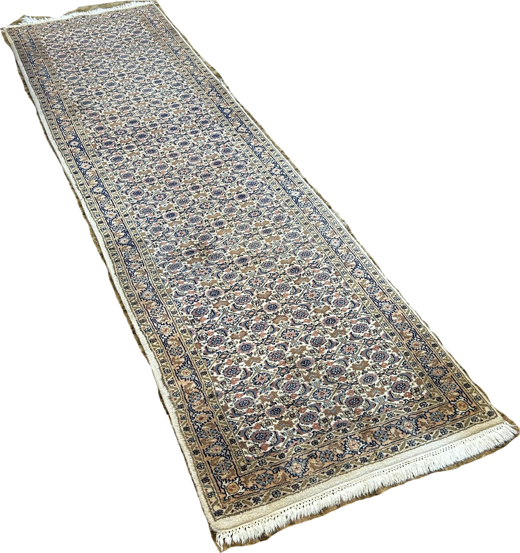 A Persian Kashan Runner with a tightly packed all over floral pattern, 315cm x 80cm approximately