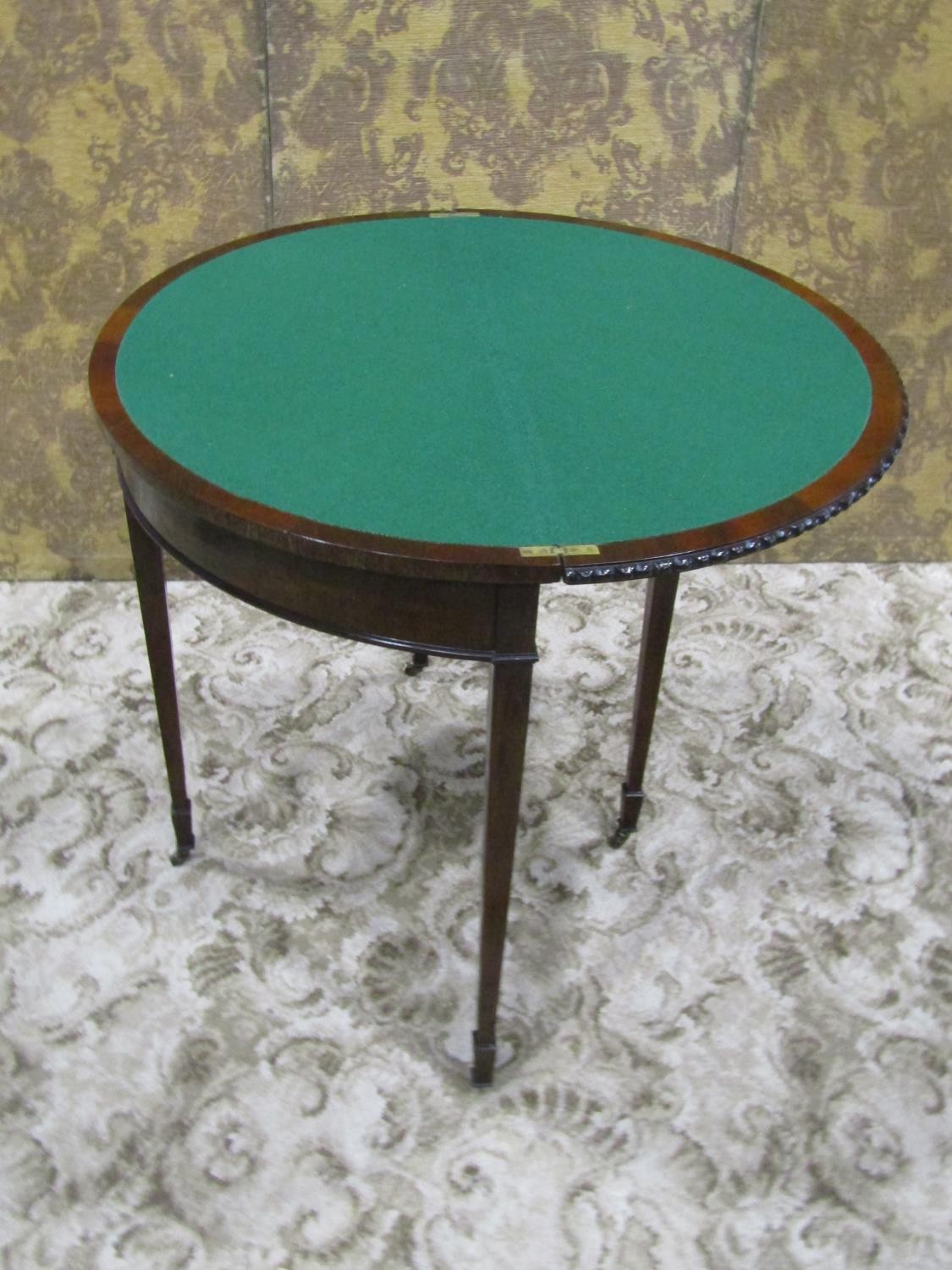 An Edwardian mahogany demi-lune fold over top card table in the Georgian style raised on square - Image 4 of 5