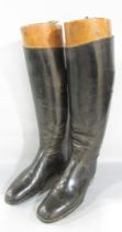 A pair of black riding boots, size 6, bought 1963, hardly worn, with wooden boot trees.