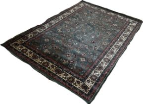 A modern Middle Eastern design carpet with an all over floral pattern on a green ground 286cm x