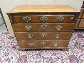 An antique mahogany chest of four drawers with bracket supports, set beneath a foldover top, 100cm