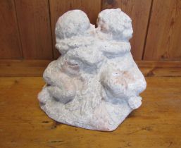 A faux weathered terracotta garden ornament in the form of kissing cherubs, 26 cm high