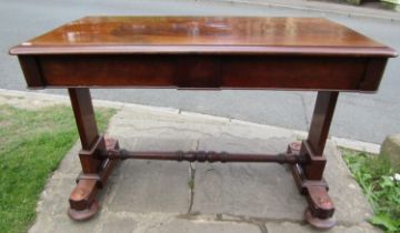 A Victorian mahogany side table enclosing two frieze drawers raised on a stretcher base with central