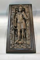 A 19th century or earlier continental carved oak panel, depicting a Roman centurion set within