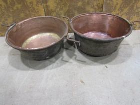 Two large 19th century copper pans with central iron handles, 60cm diameter