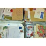 A dozen boxes / tins of unsorted worldwide stamps
