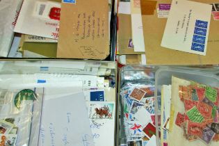 A dozen boxes / tins of unsorted worldwide stamps