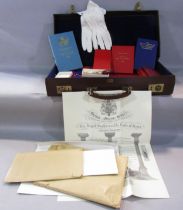A Masonic lodge case containing aprons, books on regulations, investitures and constitutions, a pair