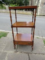 Early 19th century three tier whatnot on turned supports incorporating a lower frieze drawer on