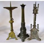 Three 19th century candlesticks / lamps: A gilt brass ecclesiastical brass example, with broad