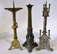 Three 19th century candlesticks / lamps: A gilt brass ecclesiastical brass example, with broad