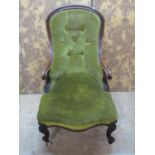 A Victorian drawing room chair with upholstered seat and button back with a shaped carved and