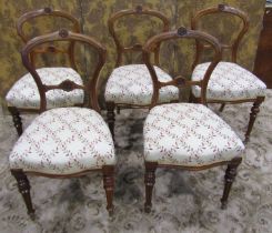 A set of five Victorian walnut balloon back dining chairs with carved and moulded frames