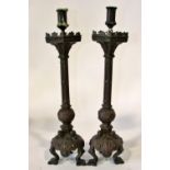 A pair of 19th century continental bronze ecclesiastical candlesticks, with crucifix and other