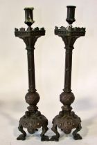 A pair of 19th century continental bronze ecclesiastical candlesticks, with crucifix and other