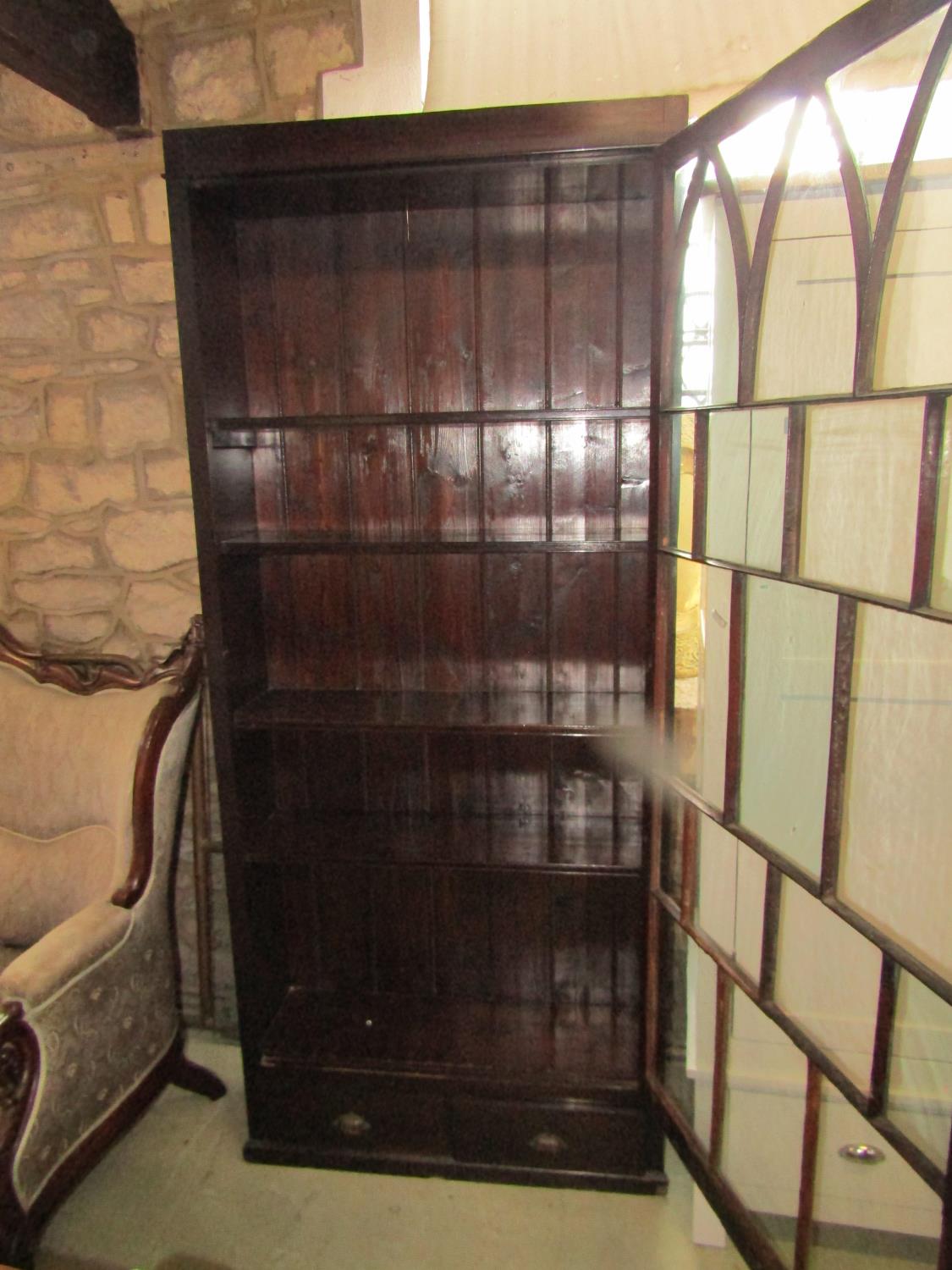 A 19th century mahogany bookcase of full height enclosed by an astragal glazed panelled door over