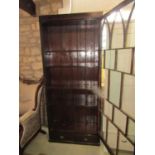 A 19th century mahogany bookcase of full height enclosed by an astragal glazed panelled door over