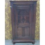 An old English style carved oak side cupboard in the Elizabethan style with panelled framework and