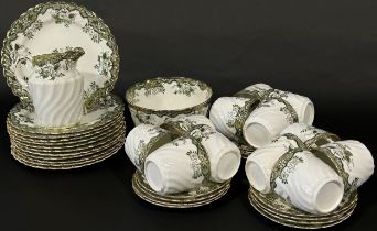 A Victorian tea service for twelve with transfer printed green ground floral detail within gilded