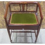 An inlaid Edwardian mahogany piano stool with hinged upholstered box seat beneath a shaped and