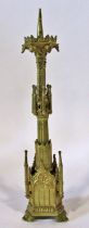 A 19th century Puginesque gilt cast brass pricked candlestick, of architectural form, the base