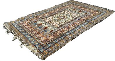 A Middle Eastern Carpet with a central panel and a grid of stylised flowers 300 x 200cm