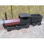 A rustic wooden scratch-built model of a steam engine and tender, with painted finish