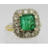 Mid 20th century 18ct emerald and diamond cluster ring, the emerald 7 x 7mm approx, size N, 5.3g (