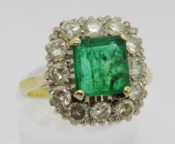 Mid 20th century 18ct emerald and diamond cluster ring, the emerald 7 x 7mm approx, size N, 5.3g (