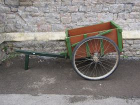 A vintage home built hand cart with original green and brown painted finish