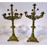 A pair of 19th century seven light gilt brass ecclesiastical candelabra, with scrolling branches and