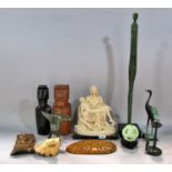 A box of worldwide souvenirs, including, Bernini’s Pieta, Easter Island Heads, Chinese Libation Cup,