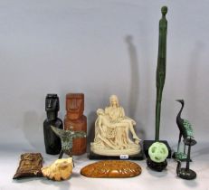 A box of worldwide souvenirs, including, Bernini’s Pieta, Easter Island Heads, Chinese Libation Cup,