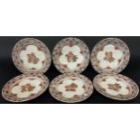 Six Japanese porcelain plates with chrysanthemum detail within repeating scaled borders, 22 cm