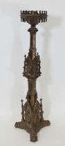 A 19th century continental brass ecclesiastical gothic candlestick, with a pointed hexagonal