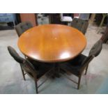 A mid century extending teak wood dining table by MacIntosh with two additional leaves and four