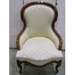 A Victorian style drawing room chair with upholstered finish