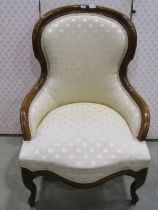 A Victorian style drawing room chair with upholstered finish