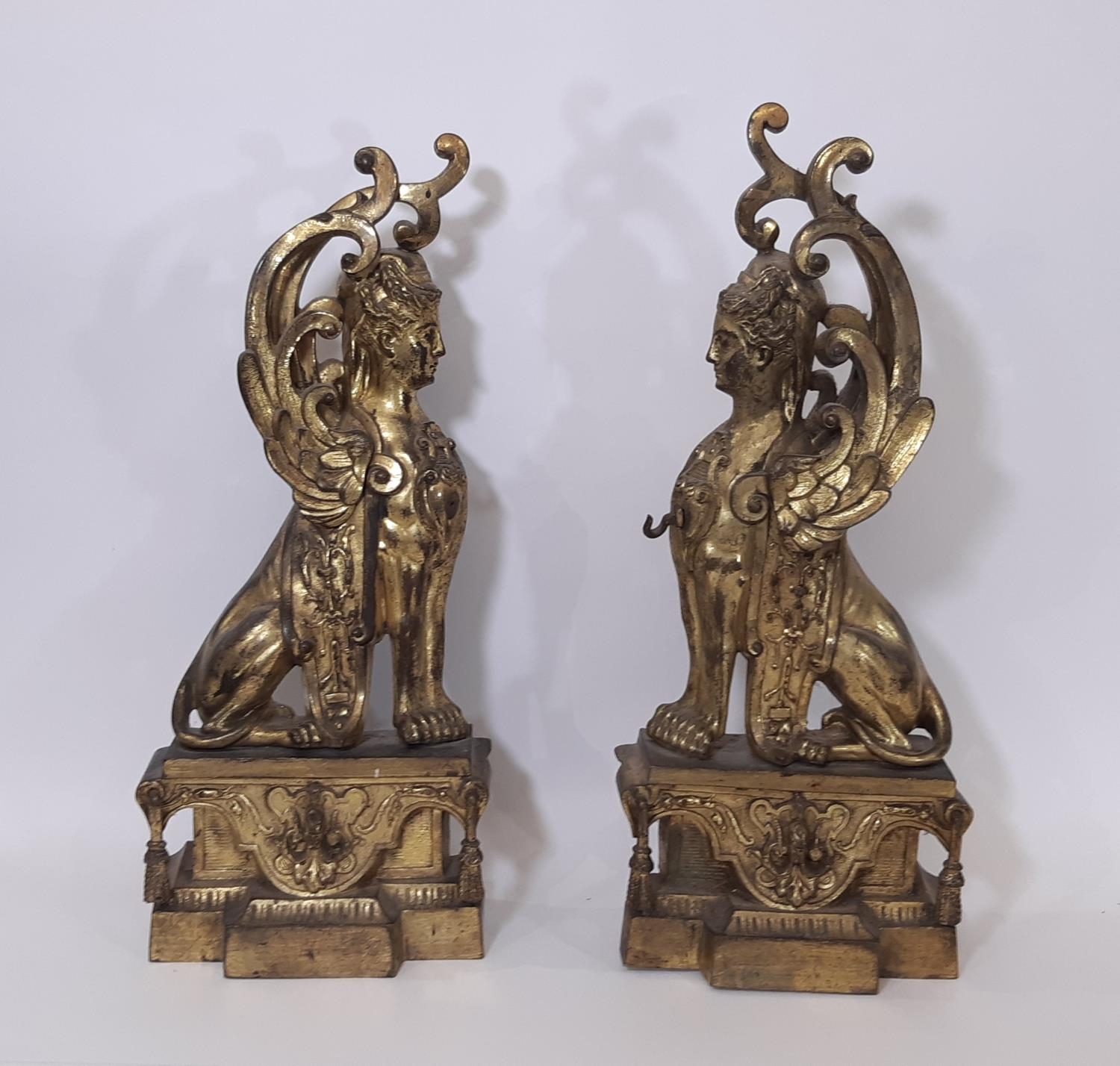 A substantial pair of 19th century cast gilt brass and ormolu fire dogs / figures in the form of