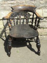 A Windsor smokers bow elbow chair principally in elm, with turned legs