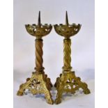 A pair of old English style ecclesiastical gilt brass pricket candlesticks, with pierced castellated