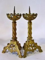 A pair of old English style ecclesiastical gilt brass pricket candlesticks, with pierced castellated